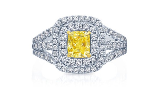 an elaborate halo ring featuring a yellow center stone and diamond accents