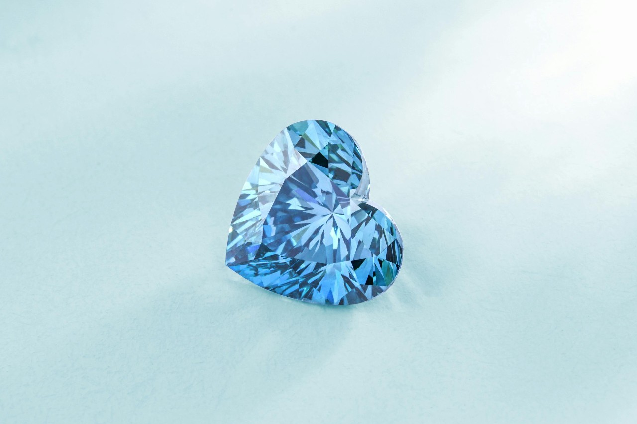 a heart shaped aquamarine against a soft blue background