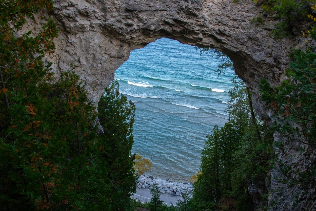 A waterside view through a rock arch on Mackinac Island.