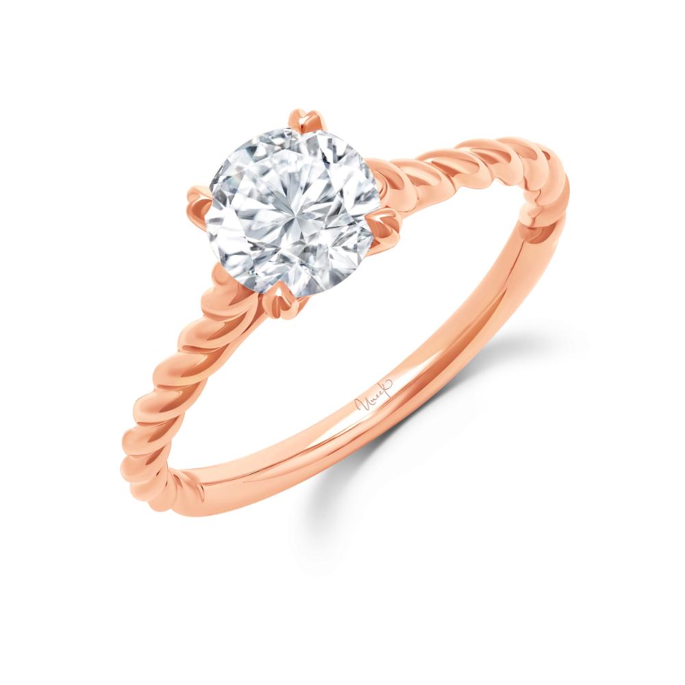 A rose gold solitaire diamond engagement ring.