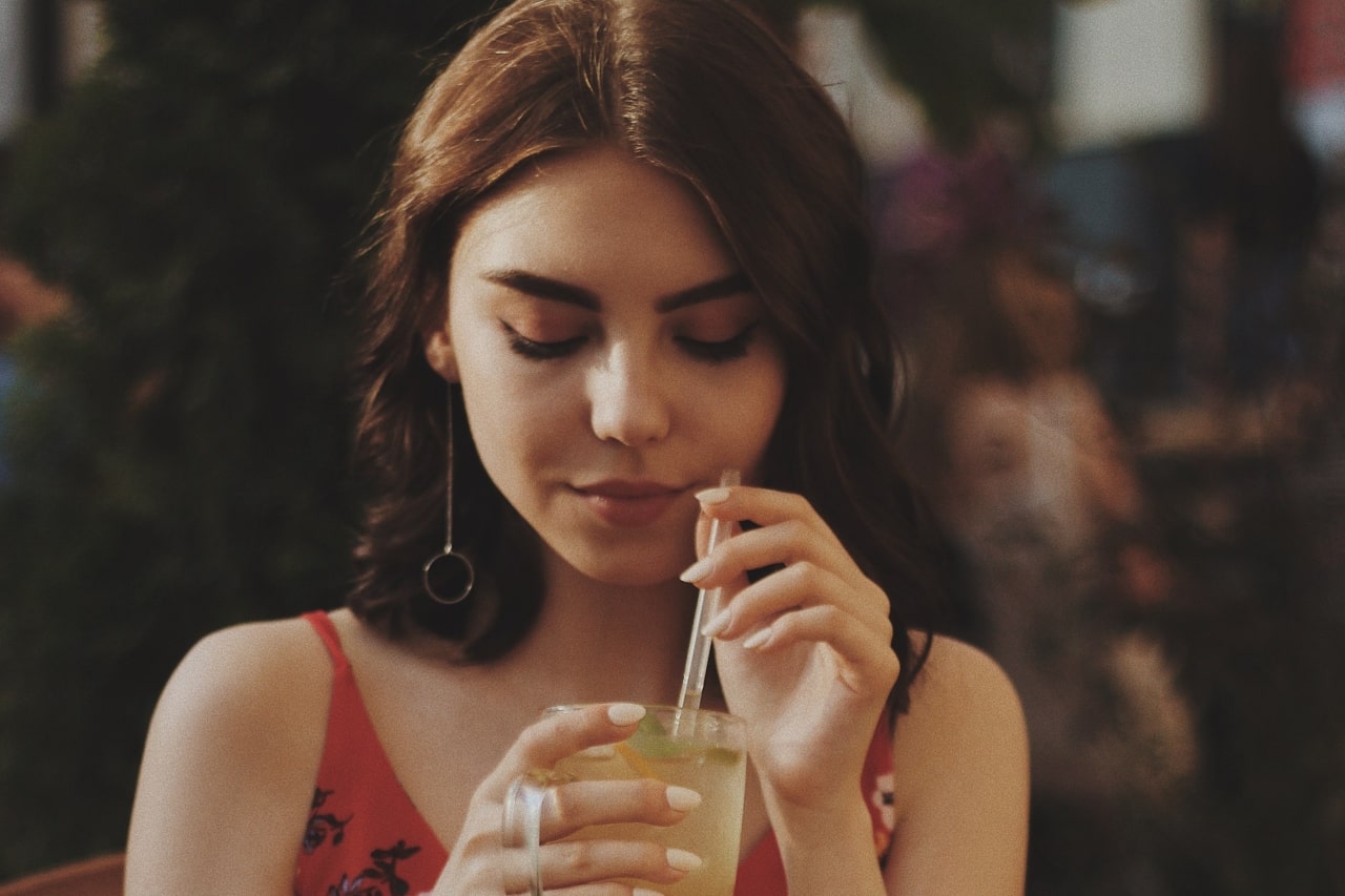 Woman with earrings drinking tea